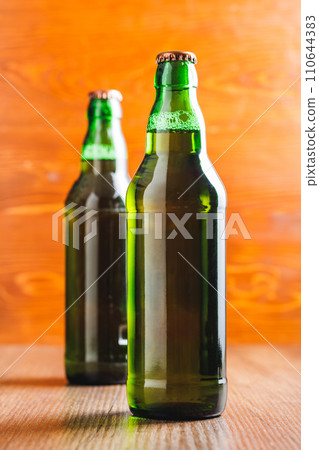 Bottles of beer on wooden table. Bottles of beer on wooden table. 110644383