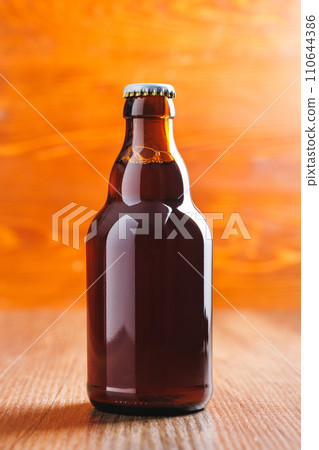 Bottle of beer on wooden table. Bottle of beer on wooden table. 110644386