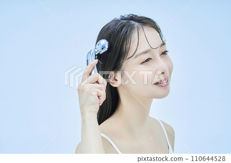 Young woman self-massaging her face 110644528