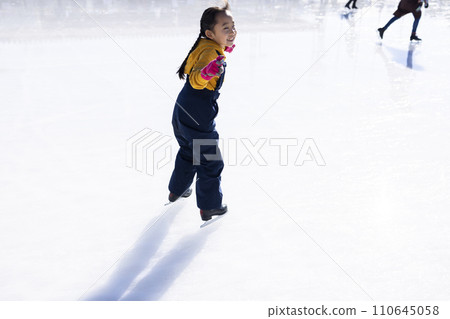 Girl enjoying ice skating outdoors Girl enjoying ice skating outdoors 110645058