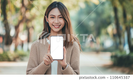AI-generated content. Woman Holding Up Smart Phone With White Screen AI-generated content. Woman Holding Up Smart Phone With White Screen 110645387