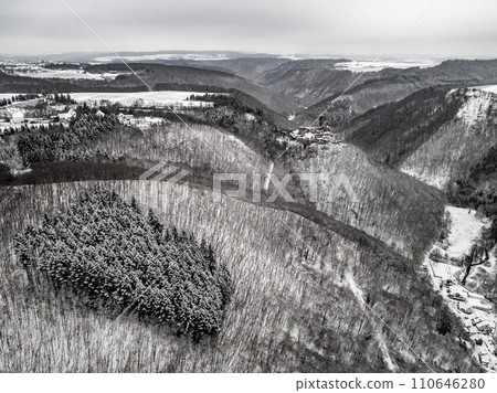 aerial view rock with medieval castle Ehrenburg near moselle river Brodenbach white winter snow wonderland forest hills 110646280