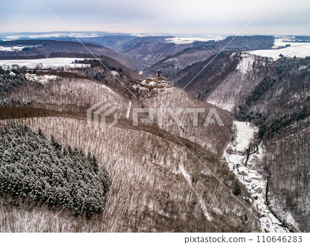 aerial view rock with medieval castle Ehrenburg near moselle river Brodenbach white winter snow wonderland forest hills 110646283