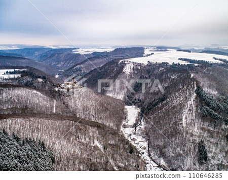 aerial view rock with medieval castle Ehrenburg near moselle river Brodenbach white winter snow wonderland forest hills 110646285