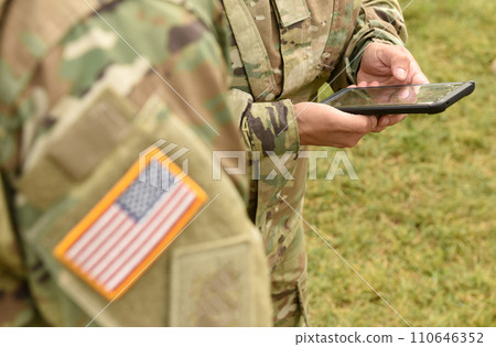 US soldier use smartphone 110646352