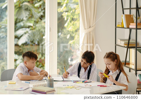 Group of kids practicing writing letters of English alphabet 110646800