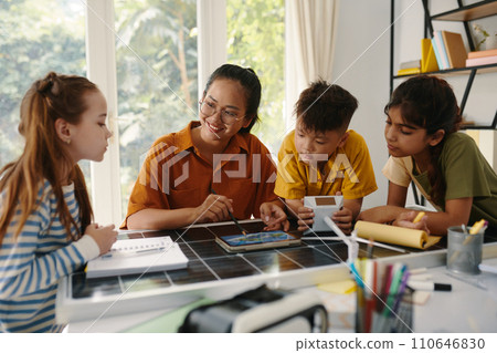 Curious kids learning about renewable energy in class 110646830