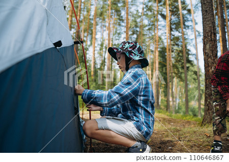 cute little caucasian boy putting up a tent. Family camping concept 110646867