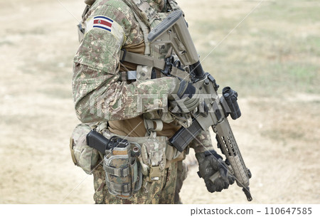 Soldier with assault rifle and flag of Costa Ricaa on military uniform. Collage. 110647585