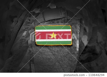 Flag of Suriname on soldier arm. Flag of Suriname on military uniforms (collage). Flag of Suriname on soldier arm. Flag of Suriname on military uniforms (collage). 110648294