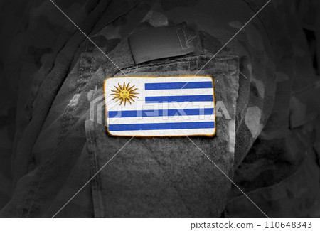 Flag of Uruguay on soldiers arm. Flag of Uruguay on military uniforms (collage). 110648343