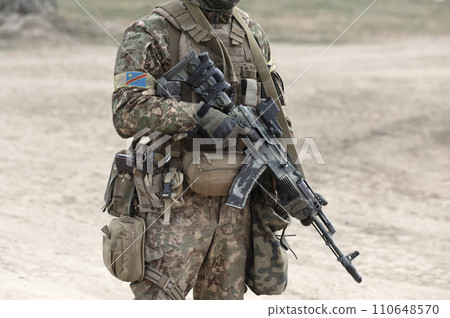 Soldier with machine gun and flag of Democratic Republic of the Congo on military uniform. Collage. 110648570