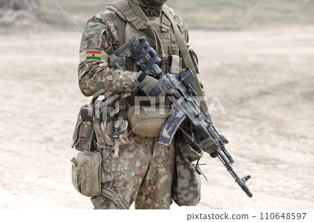 Soldier with assault rifle and flag of Ghana on military uniform. Collage. 110648597