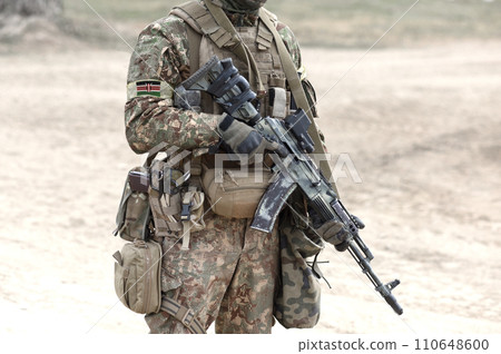 Soldier with assault rifle and flag of Kenya on military uniform. Collage. Soldier with assault rifle and flag of Kenya on military uniform. Collage. 110648600