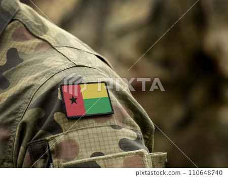 Flag of Guinea-Bissau on military uniform. Army, troops, soldiers, Africa, (collage). 110648740