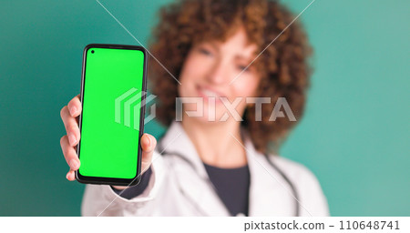 Happy crop woman doctor showing chromakey on smartphone 110648741