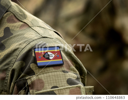 Eswatini, also known as Swaziland flag on soldiers arm. Kingdom of Eswatini flag on military uniform. Army, troops, military, Africa (collage). Eswatini, also known as Swaziland flag on soldiers arm. Kingdom of Eswatini flag on military uniform. Army, troops, military, Africa (collage). 110648863