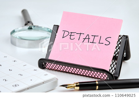 DETAILS word on the sticker on the stand on a white background next to a fountain pen, calculator and magnifying glass on a white background DETAILS word on the sticker on the stand on a white background next to a fountain pen, calculator and magnifying glass on a white background 110649025