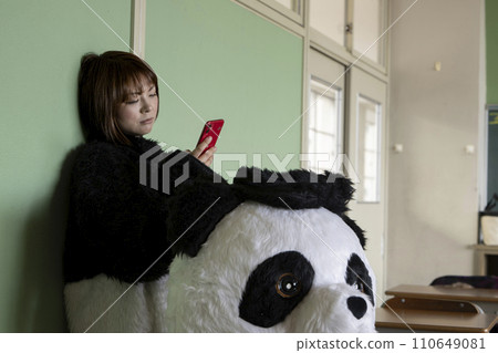 A part-time woman wearing a costume taking a break at an event A part-time woman wearing a costume taking a break at an event 110649081