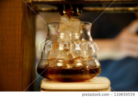 coffee being poured into a coffee server coffee being poured into a coffee server 110650559