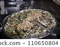 Fried rice with vegetables on a hot pan in a restaurant. 110650804
