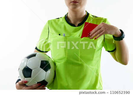 Young woman, female soccer referee holding ball, stopping game and showing red card against white studio background 110652390