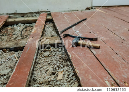 Old wooden floor repairing. Old planks on the floor. Old wooden floor repairing. Old planks on the floor. 110652563