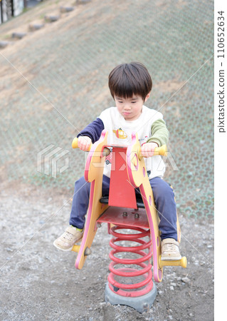 A boy playing in a park A boy playing in a park 110652634