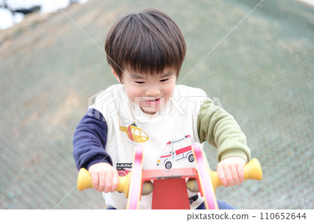 A boy playing in a park 110652644