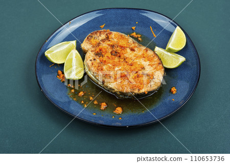 Roasted salmon steak in orange marinade. Roasted salmon steak in orange marinade. 110653736