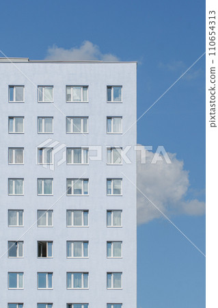 the pale blue facade of an apartment building against a clear sky the pale blue facade of an apartment building against a clear sky 110654313