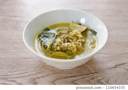 spicy boiled slice beef meat with eggplant in coconut milk green curry soup on bowl spicy boiled slice beef meat with eggplant in coconut milk green curry soup on bowl 110654335