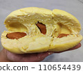 Closeup lady hand holding yellowish organic riped durian with tiny seeds isolated on grey background, Southeast asia tropical smell fruit 110654439