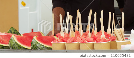 Cups with sliced portions of watermelon ready to be sold in the stall at the Naplavka farmers market Cups with sliced portions of watermelon ready to be sold in the stall at the Naplavka farmers market 110655481