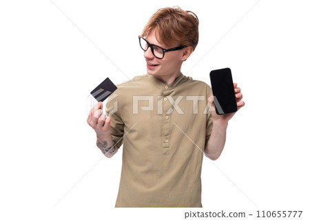 handsome young caucasian male promoter with red hair and a tattoo on his arm dressed in a khaki 110655777