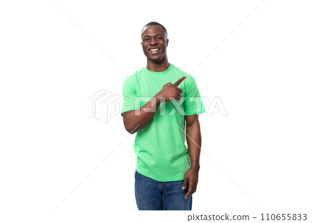 young leader african man dressed in a green t-shirt and jeans actively gesturing on a white young leader african man dressed in a green t-shirt and jeans actively gesturing on a white 110655833