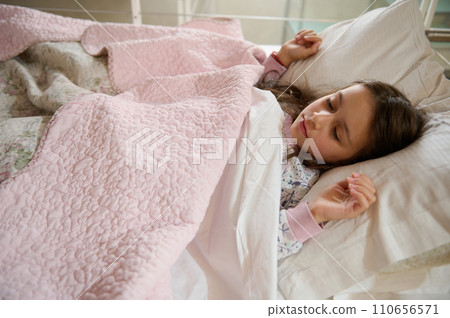 Authentic portrait of a Caucasian little kid girl sleeping on the bed Authentic portrait of a Caucasian little kid girl sleeping on the bed 110656571