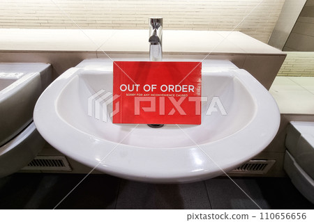 Elegant and modern wash basin with Out of Order signage placed below tap 110656656