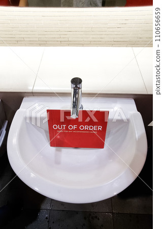 Elegant and modern wash basin with Out of Order signage placed below tap Elegant and modern wash basin with Out of Order signage placed below tap 110656659