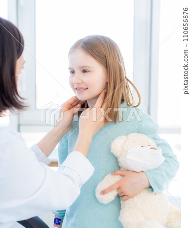 Nice little girl holding toy at medical appointment Nice little girl holding toy at medical appointment 110656876