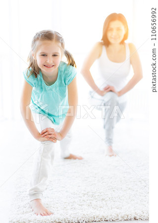 Cute little girl with mother doing gymnastic exercises Cute little girl with mother doing gymnastic exercises 110656992