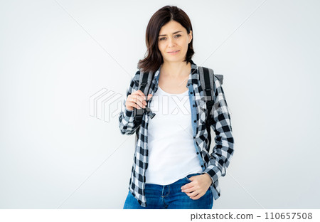 Pretty woman with backpack on a grey background 110657508