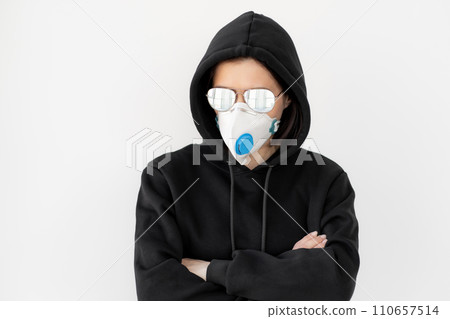 Woman in black jacket with glasses and face mask 110657514