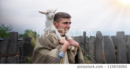 Shepherd with a sheep in his arms Shepherd with a sheep in his arms 110658060