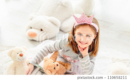 Adorable little girl in diadem with teddy bears in bright room 110658211