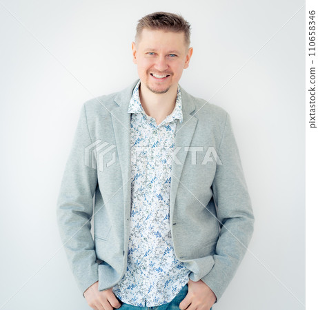 Smiling guy in floral shirt and jacket isolated on white background Smiling guy in floral shirt and jacket isolated on white background 110658346