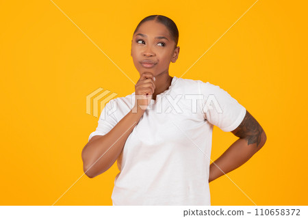 Thoughtful Black Woman Thinking Looking Aside Standing On Yellow Background Thoughtful Black Woman Thinking Looking Aside Standing On Yellow Background 110658372