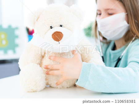 Close up view of teddy bear in medical mask 110658381