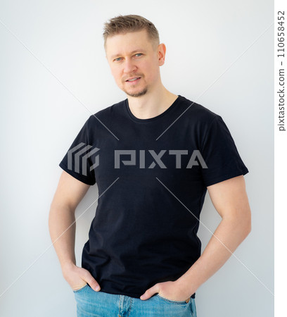 Handsome man posing in black blank t-shirt 110658452