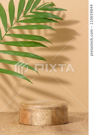 Round brown wooden stand on a beige background, a place to display cosmetics and products Round brown wooden stand on a beige background, a place to display cosmetics and products 110659844